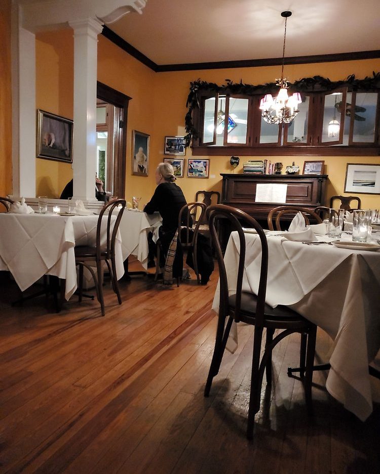 White-linen tables set for dinner in the second dining room