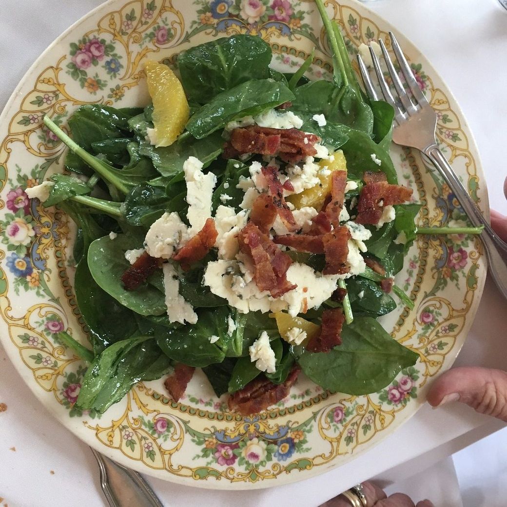 A fresh house salad plated on antique floral china