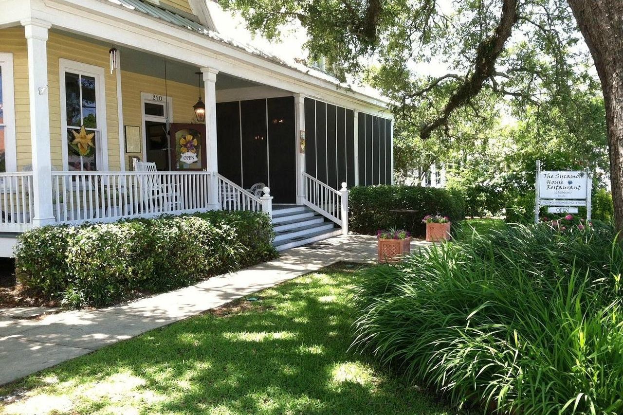 The historic Sycamore House cottage with its screened porch and oak-shaded lawn on Main Street, Bay St. Louis